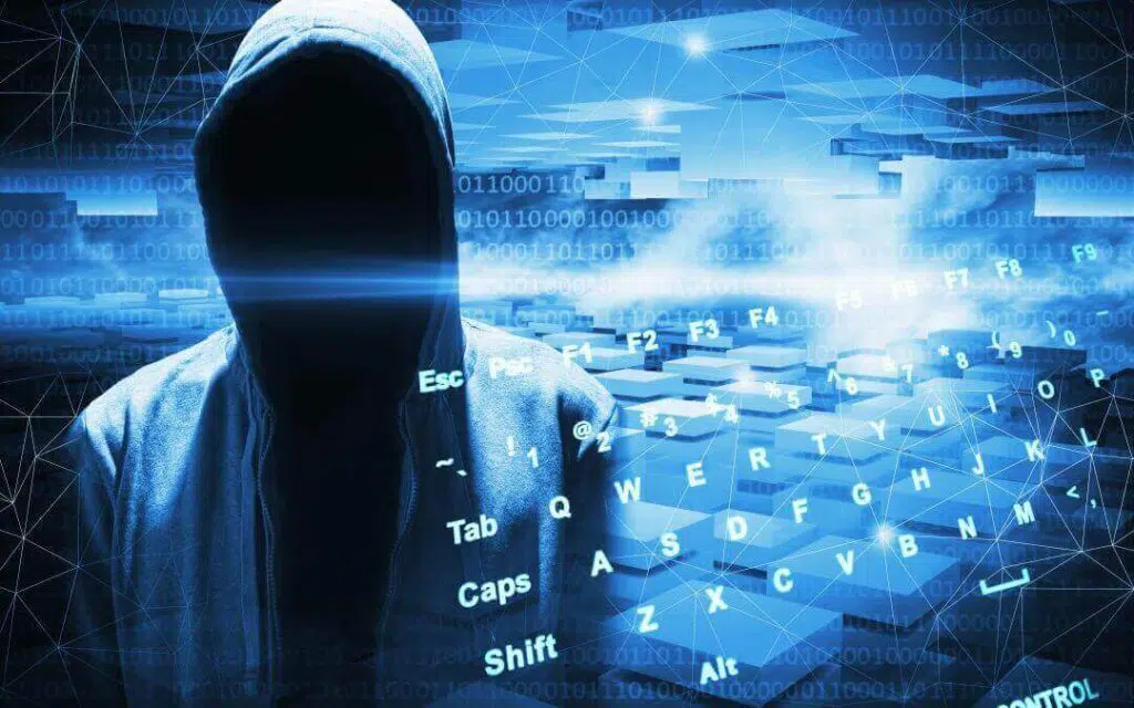 A faceless person in a grey zipper hoodie with code graphics and a keyboard graphic overlaid on the image