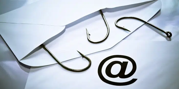An open envelope with three fish hooks falling out on top of another envelope with the '@' symbol