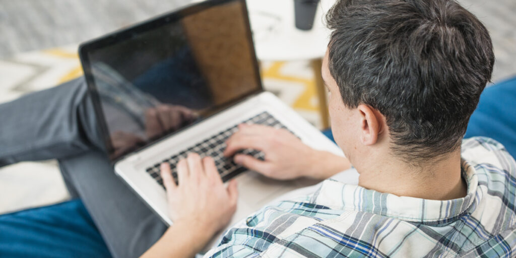 A man sitting working on a laptop