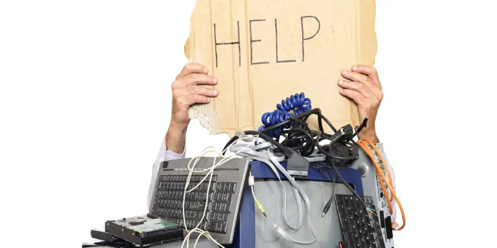 A person with computer hardware with the word Help