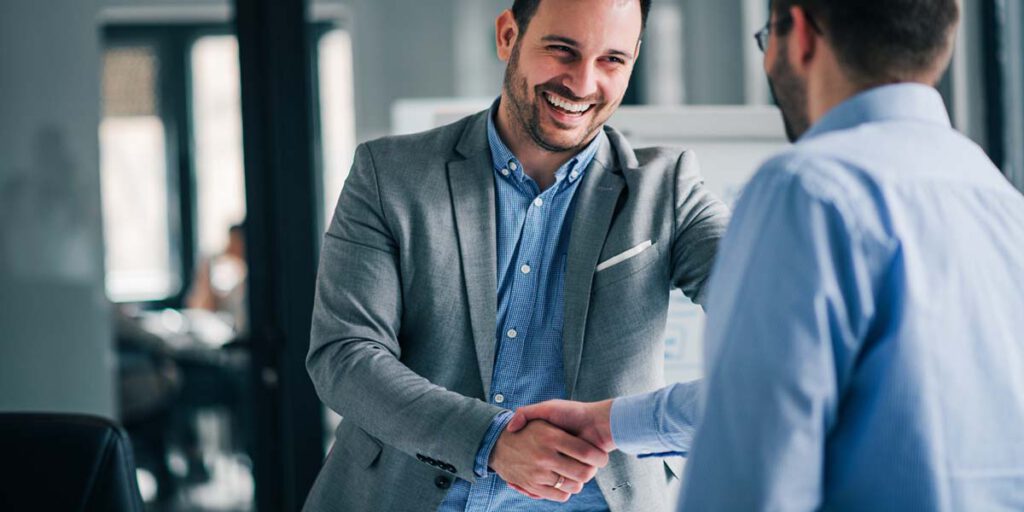 Two people in an office shaking hands