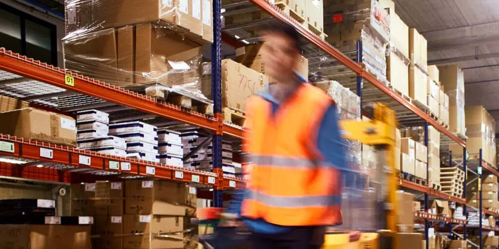 A person in a safety vest in a warehouse