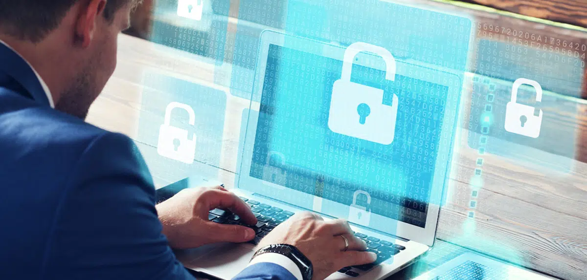 User on computer typing with open lock on screen